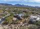 Custom home with a tile roof in a desert setting with mountain views and green grass in the distance at 9290 E Thompson Peak Pkwy # 444, Scottsdale, AZ 85255