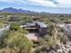 Custom home with a tile roof in a desert setting with mature trees and large circular driveway at 9290 E Thompson Peak Pkwy # 444, Scottsdale, AZ 85255