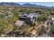 Custom home with a tile roof in a desert setting with mature trees and large circular driveway at 9290 E Thompson Peak Pkwy # 444, Scottsdale, AZ 85255