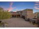 Desert home featuring a tile roof, desert landscaping, and a spacious driveway leading to a large garage at 9290 E Thompson Peak Pkwy # 444, Scottsdale, AZ 85255