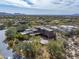 Custom home with a tile roof in a desert setting with mature trees and a large circular driveway at 9290 E Thompson Peak Pkwy # 444, Scottsdale, AZ 85255