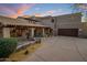 Expansive desert home featuring a tile roof, well-manicured landscaping, and a spacious driveway leading to a large garage at 9290 E Thompson Peak Pkwy # 444, Scottsdale, AZ 85255