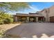 Exterior view of a home with a spacious driveway and a beautiful desert landscape at 9290 E Thompson Peak Pkwy # 444, Scottsdale, AZ 85255