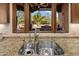 A kitchen sink with granite countertops overlooks an outdoor seating area at 9290 E Thompson Peak Pkwy # 444, Scottsdale, AZ 85255