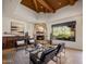 Inviting living room featuring stone fireplace, wood beam ceiling, stylish seating and a desert view window at 9290 E Thompson Peak Pkwy # 444, Scottsdale, AZ 85255