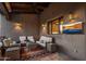 Inviting covered patio featuring comfortable seating and a wall-mounted television at 9290 E Thompson Peak Pkwy # 444, Scottsdale, AZ 85255