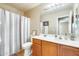 Clean bathroom with wood vanity, shower/tub combo and updated fixtures at 9477 W Frank Ave, Peoria, AZ 85382