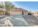 One-story house with a two-car garage and desert landscaping at 9477 W Frank Ave, Peoria, AZ 85382