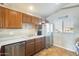 Kitchen features wood cabinets, stainless steel appliances and a window at 9477 W Frank Ave, Peoria, AZ 85382