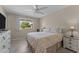 Cozy bedroom with a queen bed and ceiling fan at 9890 N Balboa Dr, Sun City, AZ 85351