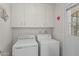 Laundry room with washer, dryer, and ample cabinet space at 9890 N Balboa Dr, Sun City, AZ 85351