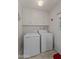 Laundry room with washer, dryer, and ample cabinet space at 9890 N Balboa Dr, Sun City, AZ 85351