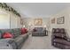 Living room with gray couches, brown recliner, and a fireplace at 9890 N Balboa Dr, Sun City, AZ 85351