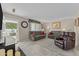 Living room with gray couches, brown recliner, and access to patio at 9890 N Balboa Dr, Sun City, AZ 85351