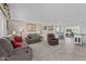 Spacious living room with gray couches, a brown recliner, and tile flooring at 9890 N Balboa Dr, Sun City, AZ 85351