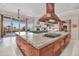 Gourmet kitchen featuring granite countertops and a copper range hood at 10040 E Happy Valley Rd # 595, Scottsdale, AZ 85255