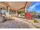 Spacious stone patio with seating, lush landscaping and pool views at 10040 E Happy Valley Rd # 595, Scottsdale, AZ 85255