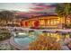 Luxury pool and spa with exterior home views at dusk at 10040 E Happy Valley Rd # 595, Scottsdale, AZ 85255