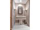 Elegant powder room with a unique floating vanity and decorative mirror at 10040 E Happy Valley Rd # 595, Scottsdale, AZ 85255