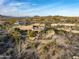 Aerial view showcasing home, pool, and desert landscape at 11077 E Cinder Cone Trl, Scottsdale, AZ 85262