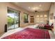 Main bedroom with patio access, fireplace, and red area rug at 11077 E Cinder Cone Trl, Scottsdale, AZ 85262