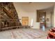 Living area with stone fireplace and access to patio at 11077 E Cinder Cone Trl, Scottsdale, AZ 85262