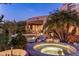 Relaxing hot tub surrounded by desert landscaping and palm trees at 11077 E Cinder Cone Trl, Scottsdale, AZ 85262