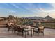 Stone patio with fire pit and mountain views at 11077 E Cinder Cone Trl, Scottsdale, AZ 85262