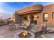 Outdoor patio with firepit and seating area, offering stunning sunset views at 11077 E Cinder Cone Trl, Scottsdale, AZ 85262