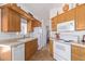 Efficient kitchen with ample storage, white appliances, and a breakfast bar at 111 S Greenfield Rd # 827, Mesa, AZ 85206