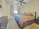 Comfortable bedroom featuring a neutral color scheme, ceiling fan, and ample natural light from the window at 11429 S Wilson Ln, Goodyear, AZ 85338