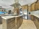 Modern kitchen with a stainless steel refrigerator and dark wood cabinets at 11429 S Wilson Ln, Goodyear, AZ 85338