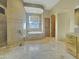 The main bathroom features stone tile, a soaking tub, a large window and a separate shower at 11429 S Wilson Ln, Goodyear, AZ 85338