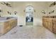 The main bathroom features dual sinks, stone tile flooring, and large walk in closet at 11429 S Wilson Ln, Goodyear, AZ 85338