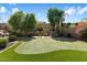 Putting green and outdoor gym nestled in a lush, landscaped backyard at 13007 W Lowden Rd, Peoria, AZ 85383