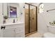 Modern bathroom with white vanity, walk-in shower, and window at 13007 W Lowden Rd, Peoria, AZ 85383