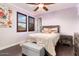 Cozy bedroom with wood floors, a ceiling fan, and a comfortable bed at 13007 W Lowden Rd, Peoria, AZ 85383