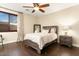 Bright bedroom with wood floors, a ceiling fan, and large window at 13007 W Lowden Rd, Peoria, AZ 85383