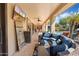 Covered patio with comfortable seating and outdoor TV at 13007 W Lowden Rd, Peoria, AZ 85383