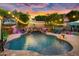 Relaxing pool area with a waterfall and string lights at 13007 W Lowden Rd, Peoria, AZ 85383