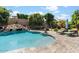 Resort-style pool with a rock waterfall and lounge chairs at 13007 W Lowden Rd, Peoria, AZ 85383