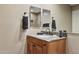 Bathroom vanity with a granite countertop, dark fixtures, and a mirror reflecting the shower at 13248 N 12Th Pl, Phoenix, AZ 85022