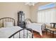 Charming bedroom with two twin beds and a classic black dresser, illuminated by a clerestory window at 13248 N 12Th Pl, Phoenix, AZ 85022