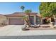 Inviting home exterior with a two-car garage, desert landscaping, tile roof, and covered entrance at 13248 N 12Th Pl, Phoenix, AZ 85022