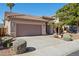 Exterior view shows a two-car garage with a paved driveway and manicured desert landscaping at 13248 N 12Th Pl, Phoenix, AZ 85022