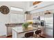 Well-lit kitchen with stainless steel appliances, granite countertops, and a breakfast bar with seating at 13248 N 12Th Pl, Phoenix, AZ 85022