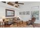 Cozy living room features neutral colors, a ceiling fan, and stylish decor at 13248 N 12Th Pl, Phoenix, AZ 85022