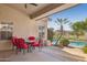 Covered patio with furniture, desert landscaping and views of the pool and golf course at 13248 N 12Th Pl, Phoenix, AZ 85022