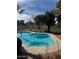 Inviting kidney-shaped pool with a brick patio and lush greenery at 13248 N 12Th Pl, Phoenix, AZ 85022