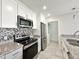 Modern kitchen with stainless steel appliances and granite counters at 1342 W Emerald Ave # 344, Mesa, AZ 85202